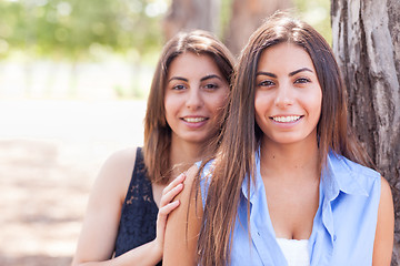 Image showing Two Beautiful Ethnic Twin Sisters Portrait Outdoors.