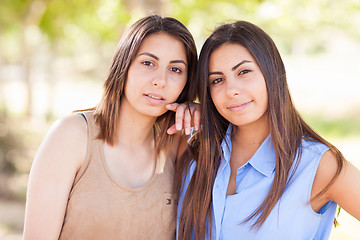 Image showing Two Beautiful Ethnic Twin Sisters Portrait Outdoors.
