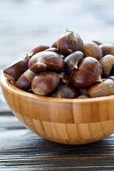 Image showing Fresh chestnuts in a wooden bowl.