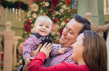 Image showing Happy Young Parents with Baby In Front of Decorated Christmas Tr