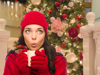 Image showing Warmly Dressed Female With Mug In Front of Decorated Christmas T