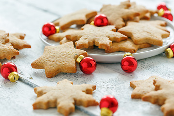 Image showing Ginger cookies and red Christmas balls.