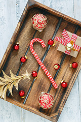 Image showing Christmas toys and candy in a wooden box.