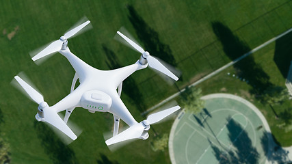 Image showing Unmanned Aircraft System (UAV) Quadcopter Drone In The Air Over 