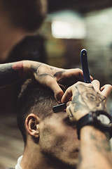 Image showing Barber shaving client