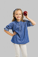 Image showing Cute girl holding an apple