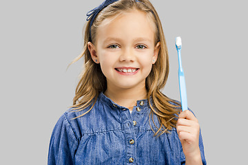 Image showing Little girl brushing teeth