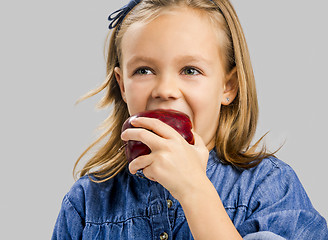 Image showing Cute girl holding an apple