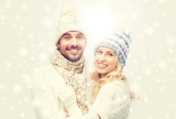 Image showing smiling couple in winter clothes hugging