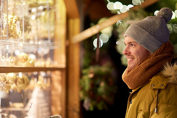 Image showing happy man looking at christmas market shop window