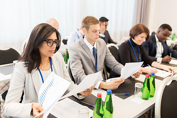 Image showing businesspeople with papers at conference