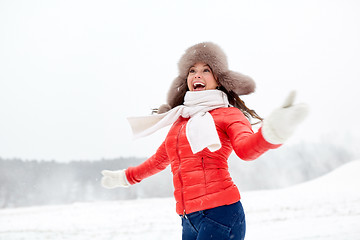 Image showing happy woman in winter fur hat having fun outdoors