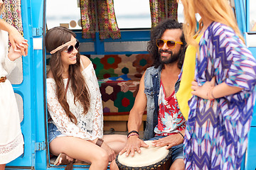 Image showing happy hippie friends playing music in minivan