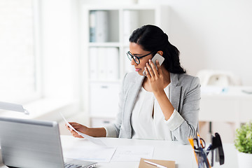 Image showing businesswoman calling on smartphone at office