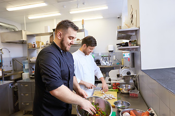 Image showing chef and cook cooking food at restaurant kitchen