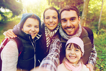 Image showing family with backpacks taking selfie and hiking