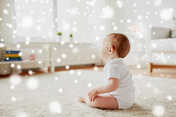 Image showing happy baby boy or girl sitting on floor at home