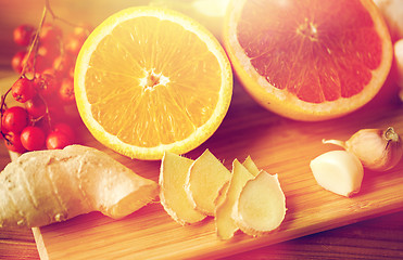 Image showing citrus, ginger, garlic and rowanberry on wood