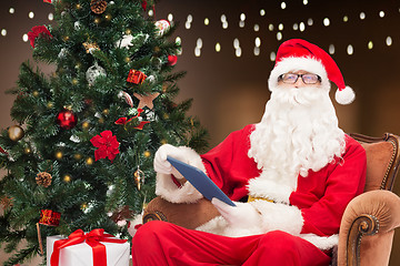 Image showing santa claus with tablet pc and christmas tree