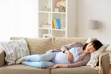 Image showing happy pregnant woman sleeping on sofa at home