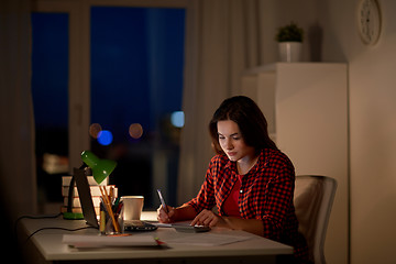 Image showing student girl with notebook and calculator at home