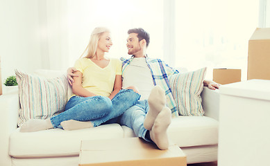 Image showing happy couple with big cardboard boxes at new home