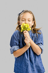 Image showing Cute litle girl holdign flowers
