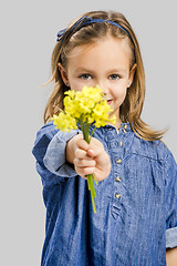 Image showing Cute litle girl holdign flowers