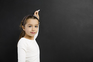 Image showing Girl writing in a blackboard