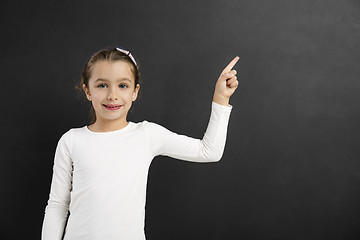 Image showing Girl pointing to a blackboard