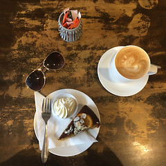 Image showing Before Shot Top View of Orange Poppyseed Cake and Coffee in cafe