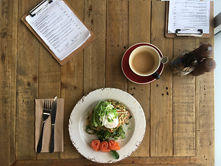 Image showing Top View zucchini fritters poached eggs avocado salmon and bulle