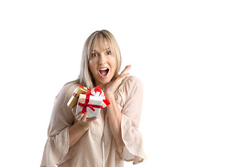 Image showing Surprised woman holding wrapped gifts on white background