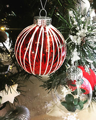 Image showing Christmas baubles and other decorations on a snowy Christmas tre