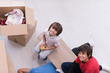 Image showing boys with cardboard boxes around them top view