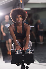 Image showing black woman doing sit ups at the gym