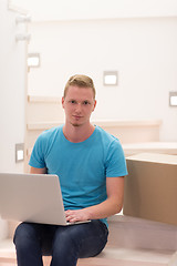 Image showing young man sitting in stairway at home