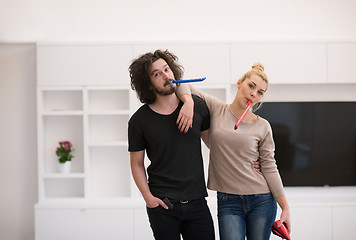 Image showing couple in party hats blowing in whistle