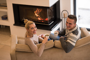 Image showing Young couple  in front of fireplace