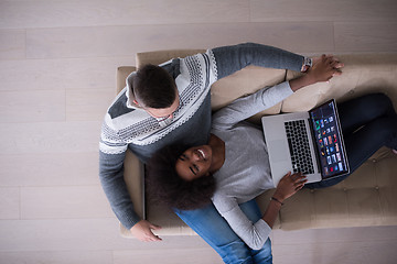 Image showing happy multiethnic couple relaxes in the living room