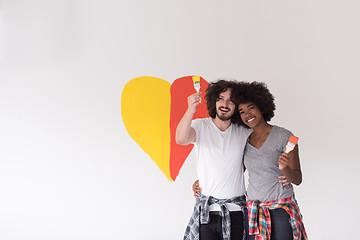 Image showing couple with painted heart on wall