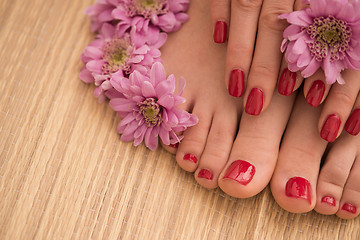 Image showing female feet and hands at spa salon