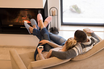 Image showing Young couple  in front of fireplace