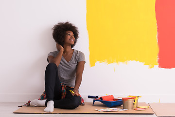 Image showing back female painter sitting on floor