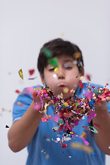 Image showing kid blowing confetti