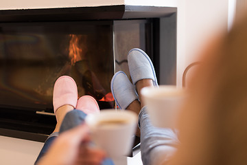 Image showing Young multiethnic couple  in front of fireplace