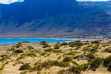 Image showing Surfers beach Famara on Lanzarote always has a red flag.