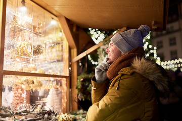 Image showing happy man looking at christmas market shop window