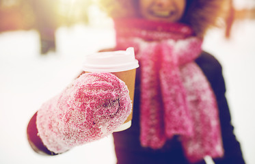 Image showing close up of hand with coffee outdoors in winter