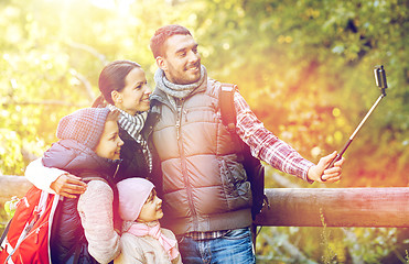 Image showing happy family with smartphone selfie stick in woods